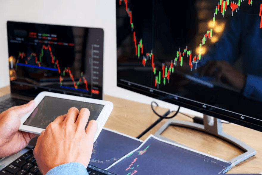 Trading charts on computer and tablet screens